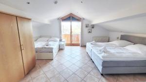 a bedroom with two beds and a large window at Gemütliche Ferienwohnung in Bodenmais I Sauna I Balkon I Blick Silberberg in Bodenmais