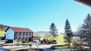 an aerial view of a large white house with trees at Gemütliche Ferienwohnung in Bodenmais I Sauna I Balkon I Blick Silberberg in Bodenmais