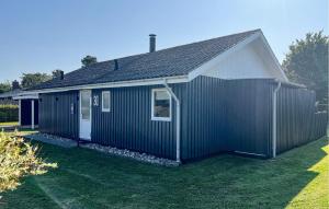 a black and white house with a yard at 3 Bedroom Lovely Home In Sydals in Neder Lysabild +12 photos