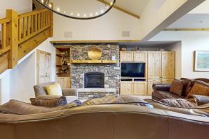 a living room with a couch and a fireplace at Lion Square Lodge East 310A in Vail