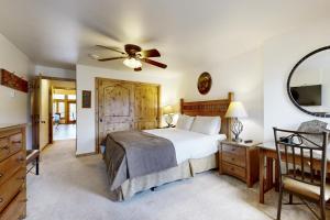 a bedroom with a bed and a ceiling fan at Lion Square Lodge East 310A in Vail +37 photos
