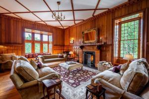 a living room filled with furniture and a fireplace at Assynt House - Exclusive Use Holiday House in Dingwall