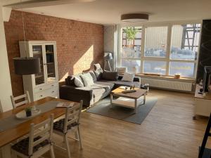 a living room with a couch and a table at Ferienwohnungen Garzke in Neustadt