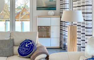 a living room with a couch and a lamp at Ferienwohnung Karlshagen in Ostseebad Karlshagen