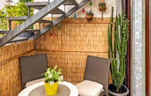 a patio with a table and two chairs and plants at Ferienwohnung Graal-Müritz in Graal-Müritz