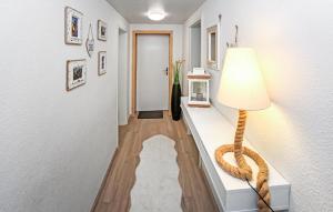 a hallway with a table with a lamp on it at Ferienwohnung Graal-Müritz in Graal-Müritz +7 photos