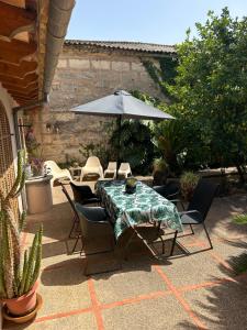 a table and chairs with an umbrella on a patio at Ca na Vilaneta in Caimari