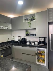 a kitchen with white cabinets and a refrigerator at Star house Guriú in Guriú