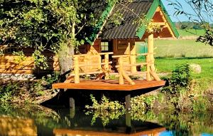 a bird house sitting on top of a pond at Lovely Home In Srokowo With Sauna in Srokowo
