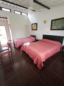 Postel nebo postele na pokoji v ubytování Tacuara Hotel