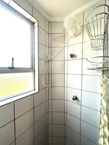 ein Badezimmer mit Dusche und Fenster in der Unterkunft Apartamento Mobiliado em Piracicaba Centro in Piracicaba