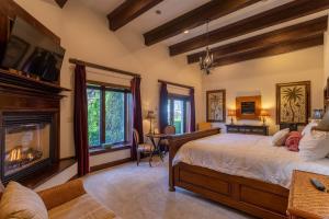 a bedroom with a bed and a fireplace at Banner Elk Winery Villa in Banner Elk