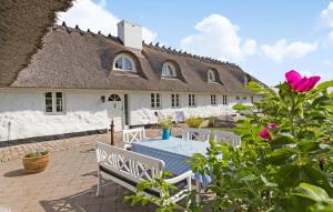 a house with a table and a bench in front of it at Gorgeous Home In Glesborg With Wifi in Glesborg +22 photos