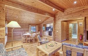 a dining room and living room of a log cabin at 2 Bedroom Stunning Home In Masserberg in Fehrenbach