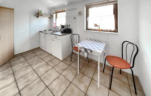 NeuhausにあるFerienwohnung Dierhagenの小さなキッチン(テーブル、椅子2脚付)