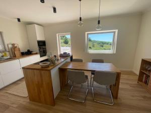 a kitchen with a wooden table and chairs at Villa Mave - Cascais in Estoril