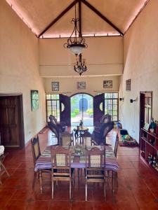 a dining room with a table and chairs and a chandelier at Casa Bella in Esquipulas