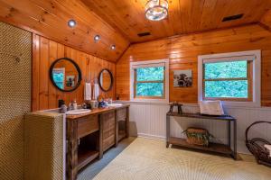 a bathroom with a sink and a wooden ceiling at A River Mist Too in Sugar Grove +57 photos