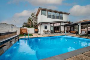 a swimming pool in front of a house at Luxury on Ocean Drive - Sleeps 28 in Corpus Christi