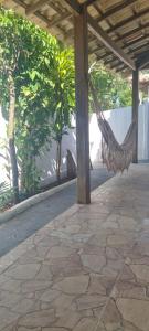 a hammock under a pavilion on a patio at Casa Recanto in Trancoso +4 photos