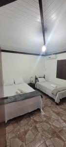 a bedroom with two beds in a room at Casa Recanto in Trancoso