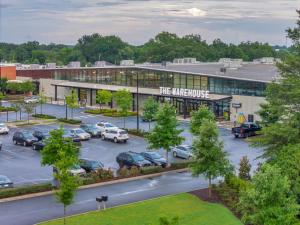 an office building with cars parked in a parking lot at Rustic Meets Modern 2BR 2BA in Greenville