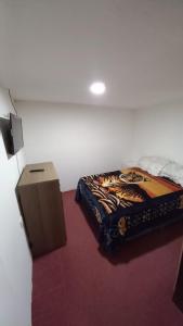 a bedroom with a zebra blanket on a bed at Departamento Amplio Familiar in Ushuaia