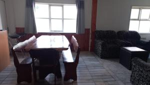 a living room with a table and chairs and a couch at Departamento Amplio Familiar in Ushuaia +1 photo