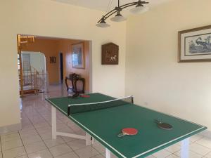 a green ping pong table in a living room at Montego Bay Sea View Guesthouse in Montego Bay
