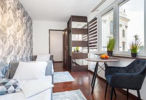 a living room with a couch and a table at Plac Uniwersytecki 15B in Wrocław
