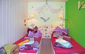 a bedroom with two beds with colorful pillows at Ferienhaus Waren Müritz in Waren