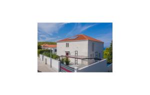 a white house with a red roof on a balcony at Luxurious Apartment In Postira in Postira