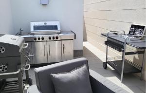 a kitchen with a stove and a chair in a room at Luxurious Apartment In Postira in Postira +19 photos