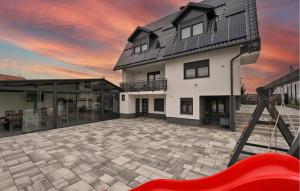 a house with a large patio with a red slide at Stunning Home In Vinogradi Ludbreski in Vinogradi Ludbreški +34 photos