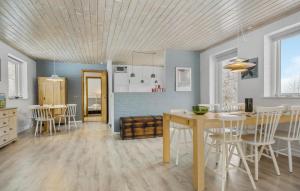 a kitchen and dining room with a table and chairs at Nice Home In Nykøbing Sj With Wifi in Nyrup