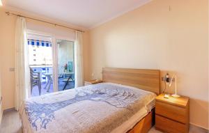 a bedroom with a large bed and a balcony at Cozy Apartment In Villajoyosa With Wifi in Villajoyosa