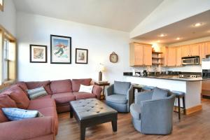 a living room with a couch and chairs and a kitchen at La Riva Del Lago Condo: Downtown, Close to Everything! in Dillon