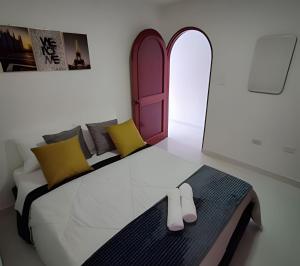 een slaapkamer met een bed met slippers erop bij ApartaEstudio con balcón e iluminado Cerca de todo in Envigado