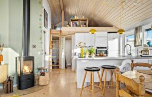 a kitchen with a fireplace and a table and chairs at Stunning Home In Haderslev With Wifi in Haderslev