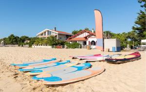 a row of surfboards lined up on a beach at Beautiful Home In Ares in Arès +21 photos