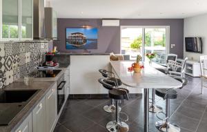 a kitchen with a table and chairs in it at Beautiful Home In Ares in Arès