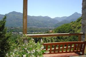 een houten bankje op een balkon met bergen op de achtergrond bij Il Trebbio in Barga