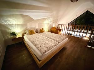 a bedroom with a large bed in a room at Cudomki nad jeziorem Krzywym in Piecki