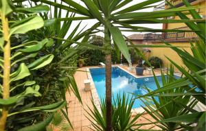 a swimming pool with plants in front of a building at Amazing Home In Trecastagni With Sauna in Trecastagni +23 photos
