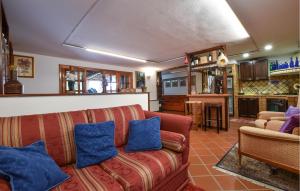 a living room with a red couch and blue pillows at Amazing Home In Trecastagni With Sauna in Trecastagni