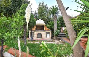 a small house in the middle of a garden at 2 Bedroom Nice Apartment In Trecastagni in Trecastagni