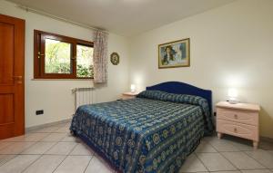 a bedroom with a bed and a dresser and a window at 2 Bedroom Nice Apartment In Trecastagni in Trecastagni