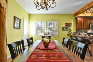 a dining room with a wooden table and chairs at Spruce Creek Lodge: Classic A-Frame Mountain Retreat in Blue River