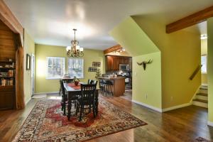 a dining room and kitchen with a table and chairs at Spruce Creek Lodge: Classic A-Frame Mountain Retreat in Blue River