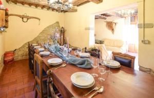 a long wooden table with wine glasses on it at Amazing Home In Pieve Santo Stefano Ar in Falcigiano